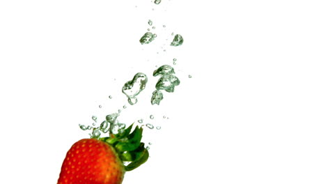 Strawberry-falling-in-water-on-white-background