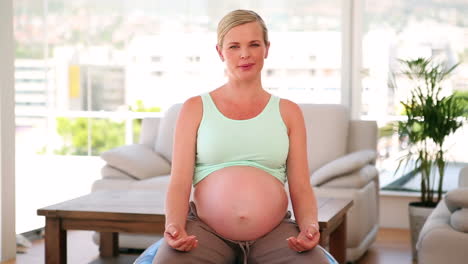 Mujer-Embarazada-Sentada-Sobre-Una-Pelota-De-Ejercicio-Azul