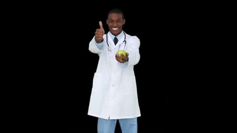 Happy-young-doctor-showing-camera-an-apple