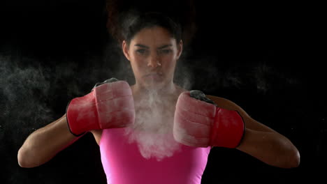 Fit-woman-in-pink-punching-fists-together