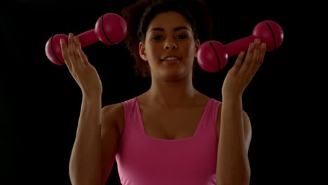 Fit-woman-in-pink-exercising-with-dumbbells
