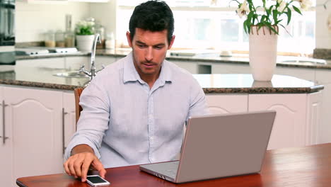 Handsome-man-using-laptop-at-the-table