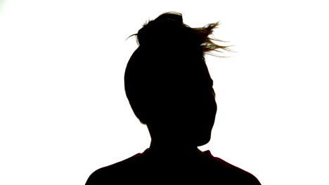 Silhouette-of-attractive-woman-shaking-her-ponytail