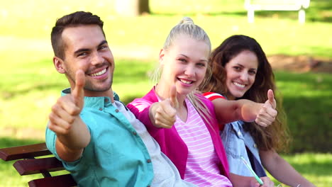 Students-sitting-together-outside-on-a-bench