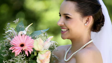 Beautiful-bride-smiling-at-camera-in-the-park