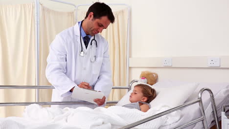 Handsome-doctor-checking-on-little-girl