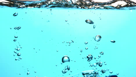 Bottle-falling-into-blue-water