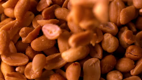 Roasted-peanuts-pouring-onto-more