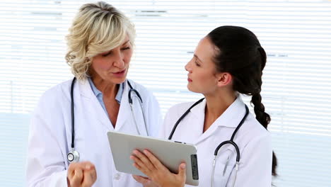 Doctor-and-nurse-discussing-something-on-tablet