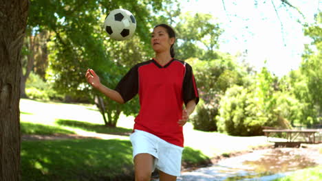 Girl-playing-football-in-the-park