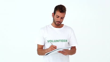 Handsome-volunteer-writing-on-notepad