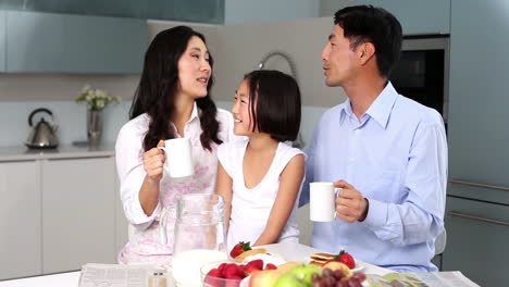 Happy-family-standing-in-kitchen