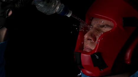Boxer-pouring-water-from-bottle-over-face