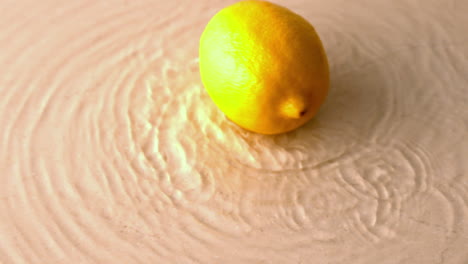 Lemon-spinning-on-wet-white-surface