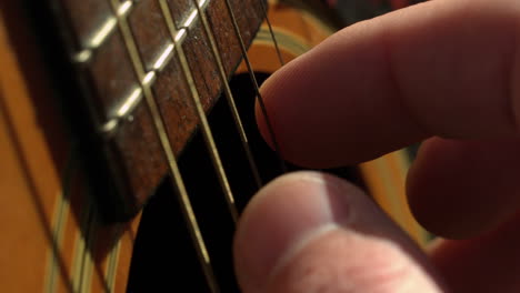 Fingers-strumming-guitar-strings