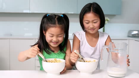 Two-happy-girls-eating-cereal