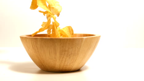 Chips-falling-in-wooden-bowl