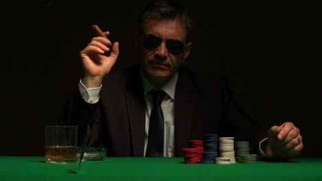 Cool-gambler-playing-poker-in-sunglasses
