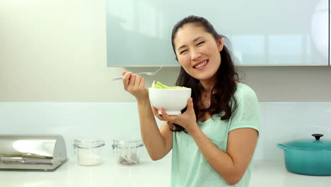 Smiling-woman-eating-salad