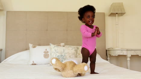 Cute-baby-girl-playing-and-clapping-on-bed