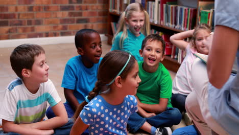 Pupils-sitting-listening-to-their-teacher-in-the-library