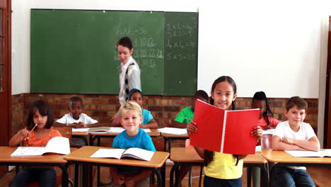 Teacher-and-pupils-all-smiling-at-camera-during-class