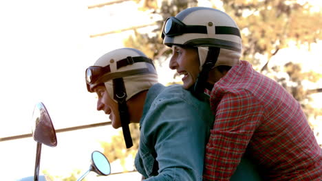 Senior-couple-riding-a-scooter-through-the-city