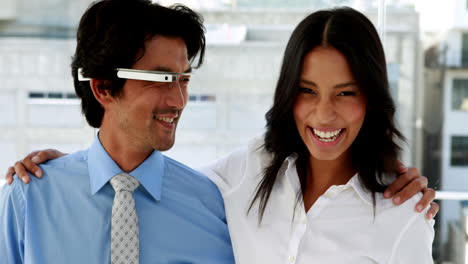Business-partners-smiling-at-camera-together-with-smart-glasses