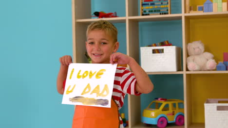 Cute-little-boy-showing-fathers-day-painting