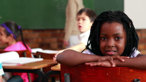 Little-girl-smiling-at-the-camera-during-class