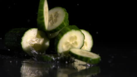 Courgette-slices-falling-on-black-background