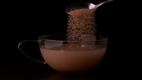 Teaspoon-pouring-sugar-into-cup-of-tea