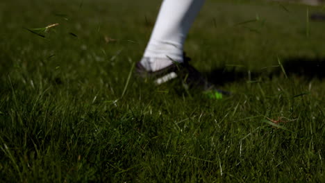 Football-player-kicking-the-ball-on-grass