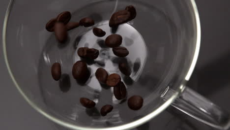 Coffee-beans-pouring-into-glass-cup