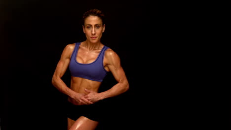 Muscular-woman-flexing-towards-camera