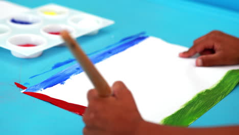 Cute-little-boy-painting-at-table