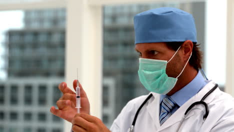 Doctor-in-mask-preparing-an-injection