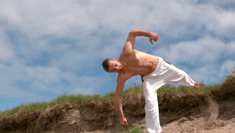Martial-arts-expert-practicing-on-the-beach