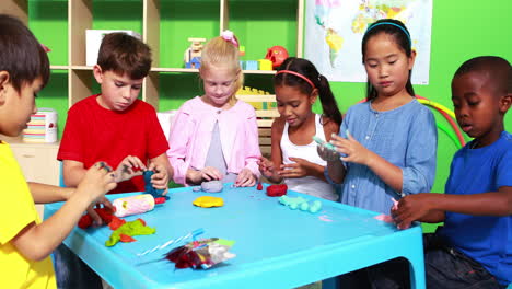 Cute-classmates-playing-with-clay-and-waving-at-camera