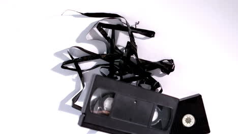 Broken-video-tape-falling-on-white-background