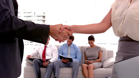 Business-people-meeting-and-shaking-hands