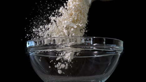 Flour-being-poured-into-glass-bowl