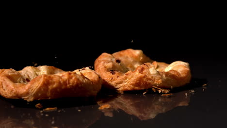 Pastry-snack-falling-on-black-background