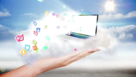 Hand-presenting-laptop-and-app-icons-in-cloud