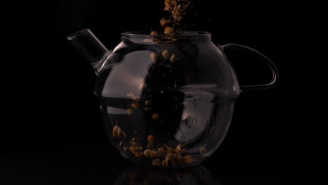 Herbal-tea-pouring-into-glass-teapot