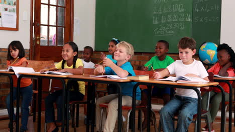 Pupils-listening-and-writing-during-class