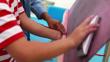 Cute-little-boys-wiping-down-mini-chalkboard