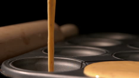 Cupcake-batter-pouring-into-baking-tray