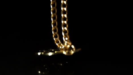 Gold-dollar-chain-falling-on-black-background