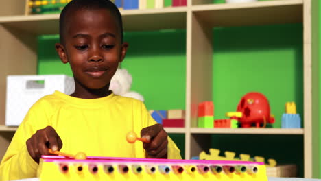 Cute-little-boy-playing-xylophone-in-classroom